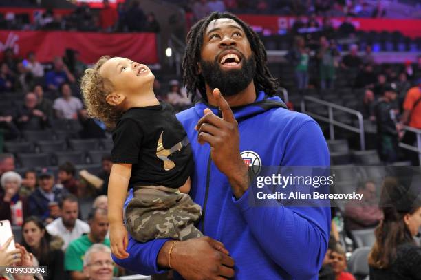 DeAndre Jordan spends a moment with his son before a basketball game between the Los Angeles Clippers and the Boston Celtics at Staples Center on...