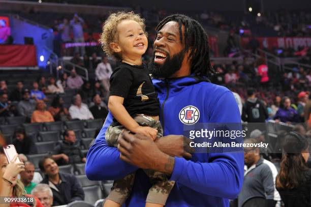 DeAndre Jordan spends a moment with his son before a basketball game between the Los Angeles Clippers and the Boston Celtics at Staples Center on...