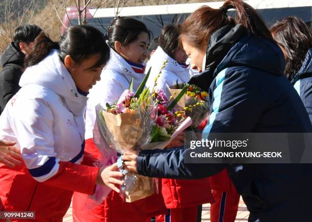 Members of North Korean women's ice hockey team are welcomed by members of the South Korean team as they arrive at South Korea's national training...