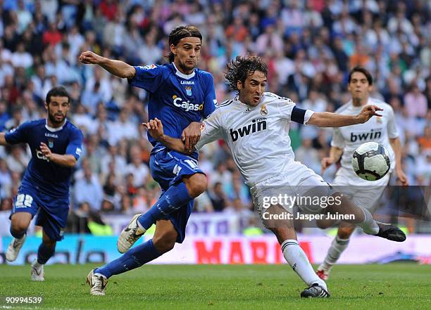 Raul Gonzalez of Real Madrid duels for the ball with David Prieto of Xerez during the La Liga match between Real Madrid and Xerez at the Estadio...