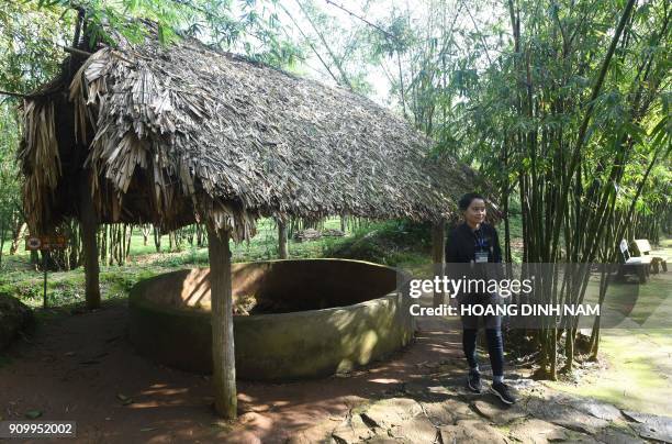 In this picture taken on January 18 a guide stands next to an air-well used for ventilation for the Vinh Moc tunnel network, at the Vinh Moc commune...