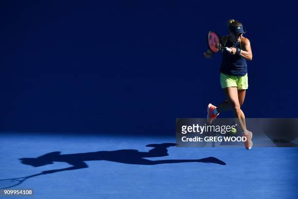Germany's Angelique Kerber hits a return against Romania's Simona Halep during their women's singles semi-finals match on day 11 of the Australian...