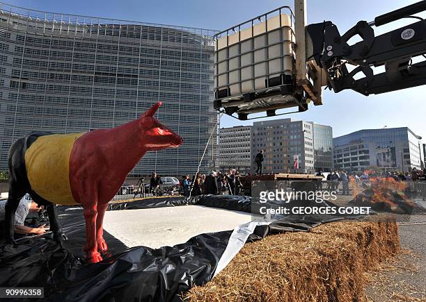 Belgian farmers dump milk in front of EU headquarters in Brussels on September 21, 2009 in Brussels to protest against plummeting milk prices....