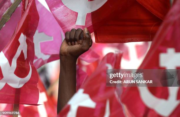 Demonstrator holds his fist in the air as members of Communist Party of India along with Trade Unions demonstrate during a national wide protest...