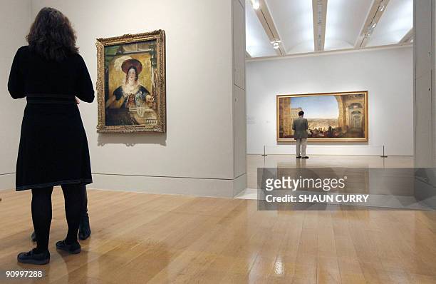 Art enthusiasts admire two painting's entitled 'Rome from the Vatican' and 'Jessica' by English artist JMW Turner during the 'Turner and the Masters'...