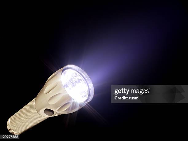 electric torch and beam in the dark, isolated on black - electric torch stock pictures, royalty-free photos & images