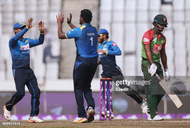 Sri Lankan cricketer Thisara Perera celebrates after the dismissal of Bangladeshi batsman Sabbir Rahman during the sixth One Day International match...