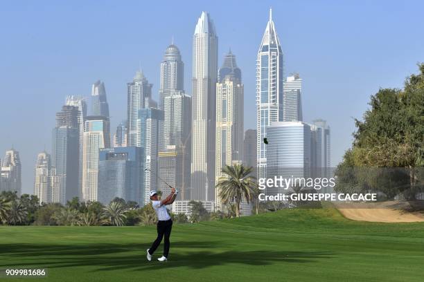 Sean Crocker of US takes a shot during the round one of the Dubai Desert Classic Golf Championship, at the Emirates Golf Club in Dubai on January 25,...