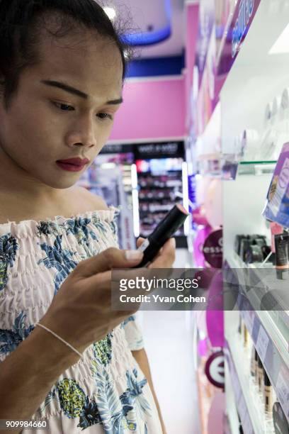 Thai transgender boxer Nong Rose checks out some make up at a local department store close to the Ban Charoensuk gym where she trains in Cholburi...