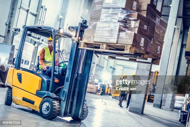 forklift moving stack of boxes - forklift stock pictures, royalty-free photos & images