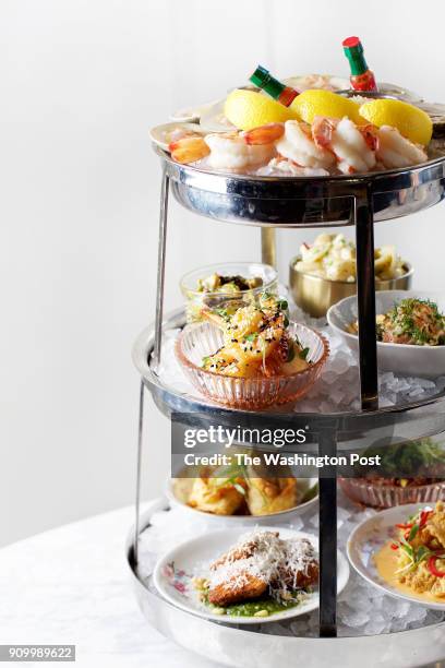 The Supreme Seafood Tower includes Chincoteague Salts Oysters, Shrimp Cocktail, Top Neck Clams, Salmon Tatar, Crispy Dragon Shrimp, Sesame Honey...
