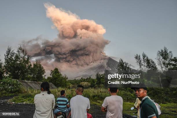 Residents look on as Mount Mayon erupts as seen from Legazpi, Albay province, Philippines, January 24, 2018. Mount Mayon, the Philipines' most active...