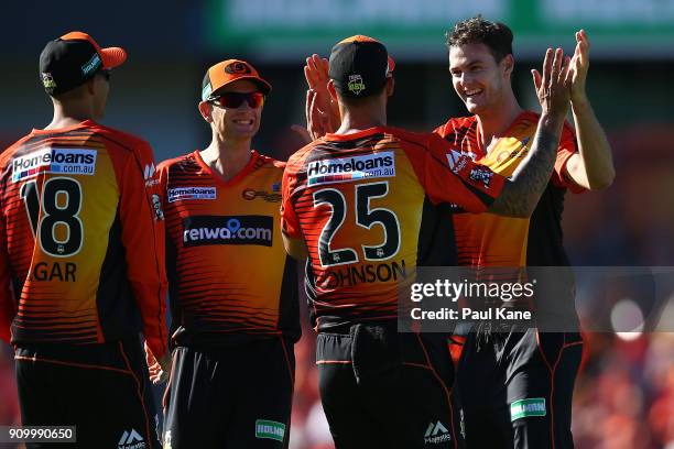 Mitchell Johnson and Matthew Kelly of the Scorchers celebrate the wicket of Jonathon Dean of the Strikers during the Big Bash League match between...