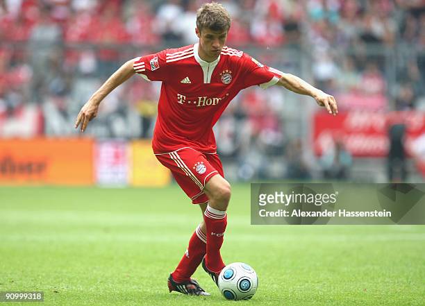 Thomas Mueller of Muenchen challenge for the ball during the Bundesliga match between FC Bayern Muenchen and 1. FC Nuernberg at Allianz Arena on...