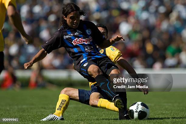 Oscar Rojas of Aguilas del America vies for the ball with Mauro Vila of Queretaro during their match for the Mexican League Apertura 2009 at the La...
