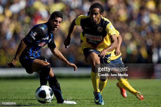 Jean Beausejour of Aguilas del America vies for the ball with Raul Rico of Queretaro during their match for the Mexican League Apertura 2009 at the...