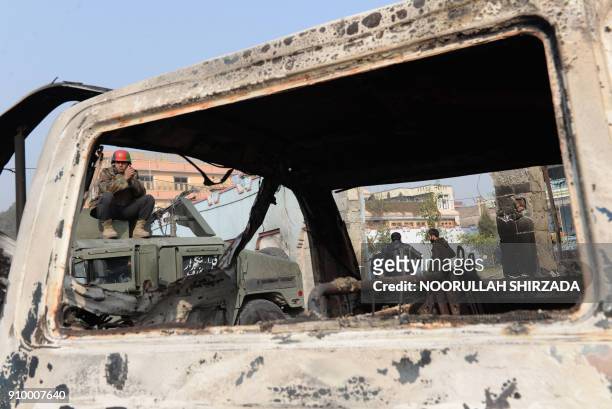 Afghan security forces inspect the site of an attack by Islamic State militants at the British charity Save the Children compound in Jalalabad on...