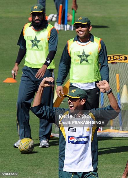 Pakistan's cricket captain Younus Khan gestures during training session as Mohammad Yousuf and Kamran Akmal look on at Wanderers in Johannesburg on...
