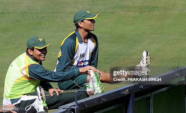 Pakistan's cricket captain Younus Khan and Kamran Akmal warm up prior to training session at Wanderers in Johannesburg on September 21, 2009. The...