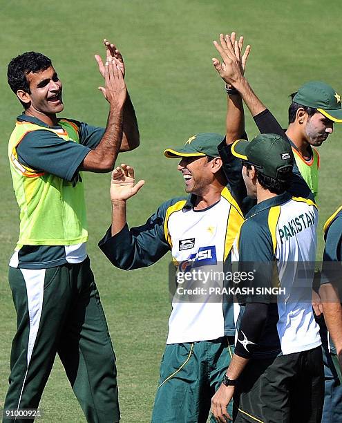 Pakistani cricket captain Younus Khan gestures during a training session as Mohammad Yousuf and Kamran Akmal look on at Wanderers in Johannesburg on...