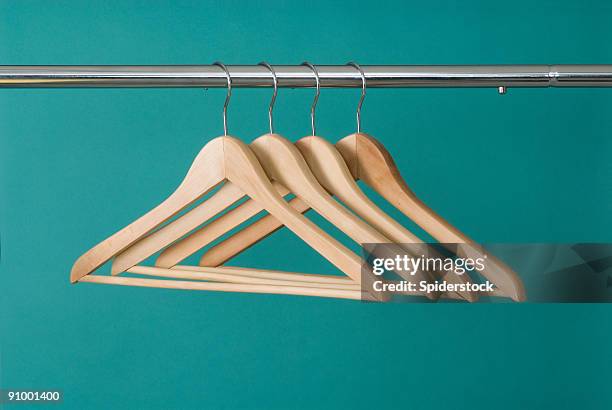 hangers on pole - clothes wardrobe stockfoto's en -beelden