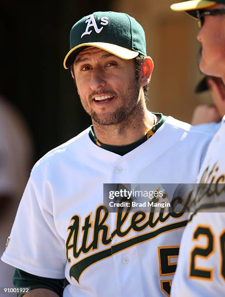 Nomar Garciaparra of the Oakland Athletics watches from the dugout against the Cleveland Indians during the game at the Oakland-Alameda County...