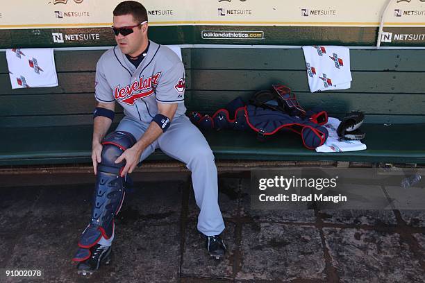 Kelly Shoppach of the Cleveland Indians gets ready in the dugout before the game against the Oakland Athletics at the Oakland-Alameda County Coliseum...