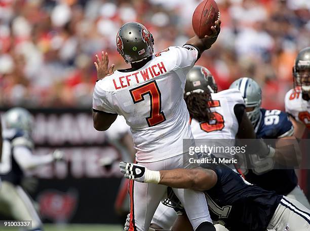 Quarterback Byron Leftwich of the Tampa Bay Buccaneers just gets a pass off as defensive end Jason Hatcher of the Dallas Cowboys is late during the...