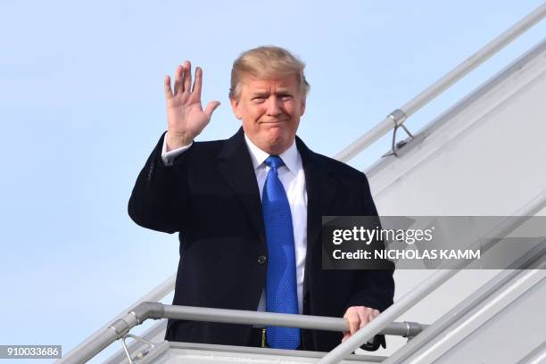 President Donald Trump waves as he arrives on January 25, 2018 in Zurich en route to the World Economic Forum in Davos. - Trump was transferring to a...