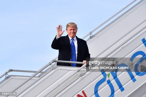 President Donald Trump waves as he arrives on January 25, 2018 in Zurich en route to the World Economic Forum in Davos. - Trump was transferring to a...