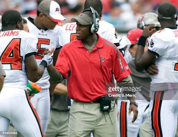 Head coach Raheem Morris of the Tampa Bay Buccaneers congratulates Carnell Williams after his touchdown against the Dallas Cowboys during the game at...
