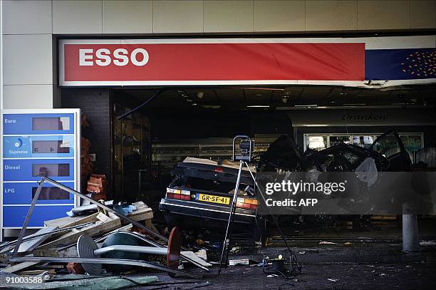 Two cars are pictured after they drove into the shop of a petrol station on the motorway A27 between the Dutch cities of Meerkerk and Gorinchem on...