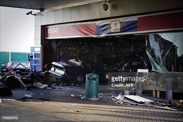Two cars are pictured after they drove into the shop of a petrol station on the motorway A27 between the Dutch cities of Meerkerk and Gorinchem on...