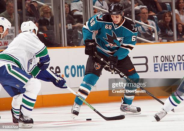 Sami Salo of the Vancouver Canucks tries to challenge Frazer McLaren of the San Jose Sharks during an NHL Preseason game on September 18, 2009 at HP...