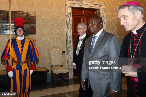 President of the Central African Republic Faustin Archange Touadera, flanked by Prefect of the Pontifical House Georg Ganswein , arrives at the...