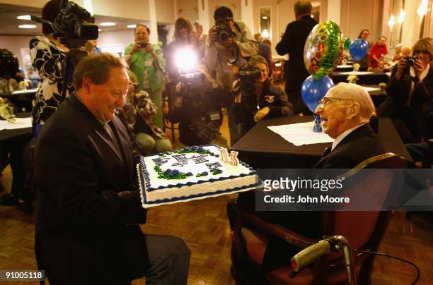 Montana Governor Brian Schweitzer holds Walter Breuning's birthday cake during Breuning's 113th birthday celebration on September 21, 2009 at the...