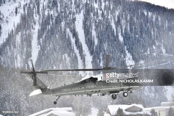 Graphic content / The "Marine One" helicopter carrying US President Donald Trump comes in to land in Davos on January 25, 2018. - Trump arrived in...