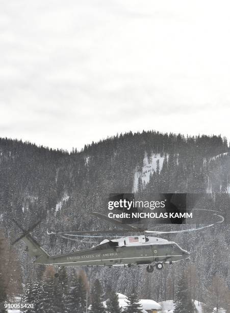 Graphic content / The "Marine One" helicopter carrying US President Donald Trump comes in to land in Davos on January 25, 2018. Trump arrived in the...