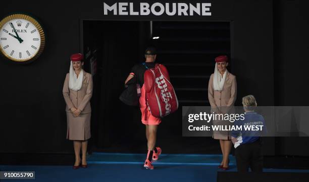 Britain's Kyle Edmund walks off the court after losing to Croatia's Marin Cilic in their men's singles semi-finals match on day 11 of the Australian...