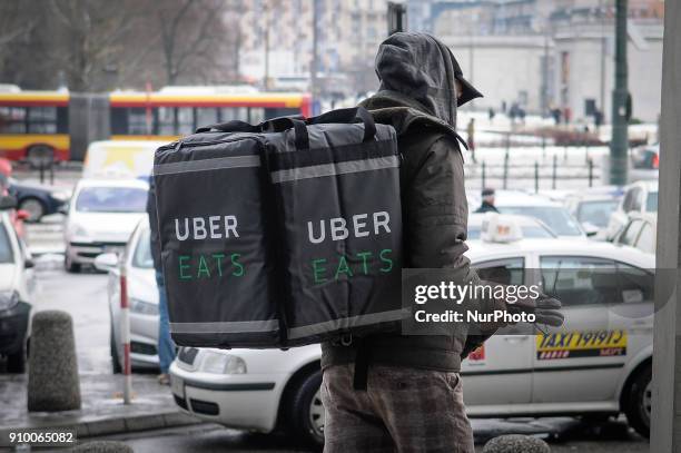 Uber eats delivery worker is seen at Warsaw Central Station, Warsaw on January 18, 2018. Uber eats contracts many foreign workers in Warsaw who...