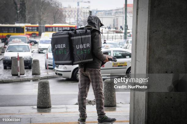 Uber eats delivery worker is seen at Warsaw Central Station, Warsaw on January 18, 2018. Uber eats contracts many foreign workers in Warsaw who...