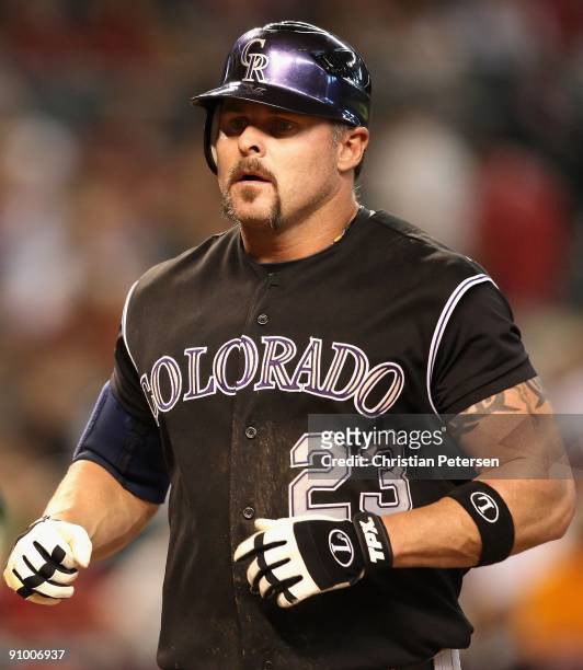 Jason Giambi of the Colorado Rockies crosses home plate after hitting a 2 run home run during the major league baseball game against the Arizona...