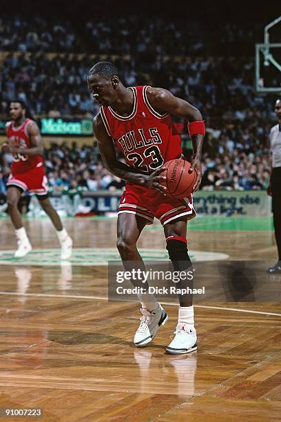 Michael Jordan of the Chicago Bulls looks to make a move against the Boston Celtics during a game played in 1988 at the Boston Garden in Boston,...