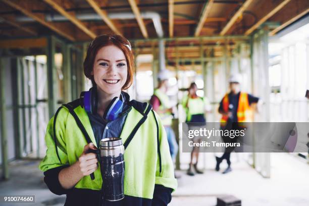 construction workers in australian in building site working and doing tasks. - australian woman stock pictures, royalty-free photos & images