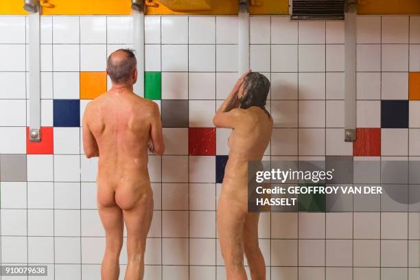 Graphic content / Nudists take a shower after a swim lesson at the Roger Le Gall swiming pool on January 12, 2018. In this pool some hours are...