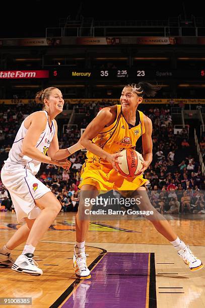 Candace Parker of the Los Angeles Sparks looks to maneuver against Nicole Ohlde of the Phoenix Mercury during the WNBA game on September 13, 2009 at...