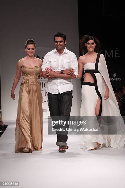 Indian actress Urvashi Sharma walks the runway with fashion designer Swapnil Shinde & model Amrit Maghera at the Swapnil Shinde show at Lakme Fashion...