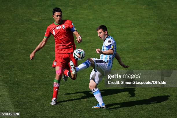 21st June 2014 - FIFA World Cup - Group F - Argentina v Iran - Lionel Messi of Argentina and Javad Nekounam of Iran .