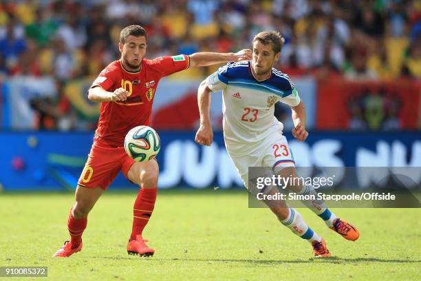 22nd June 2014 - FIFA World Cup - Group H - Belgium v Russia - Eden Hazard of Belgium battles with Dmitriy Kombarov of Russia .