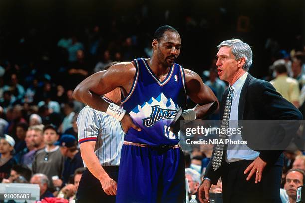 Head coach Jerry Sloan speaks with Karl Malone of the Utah Jazz during a game in 1998. NOTE TO USER: User expressly acknowledges and agrees that, by...